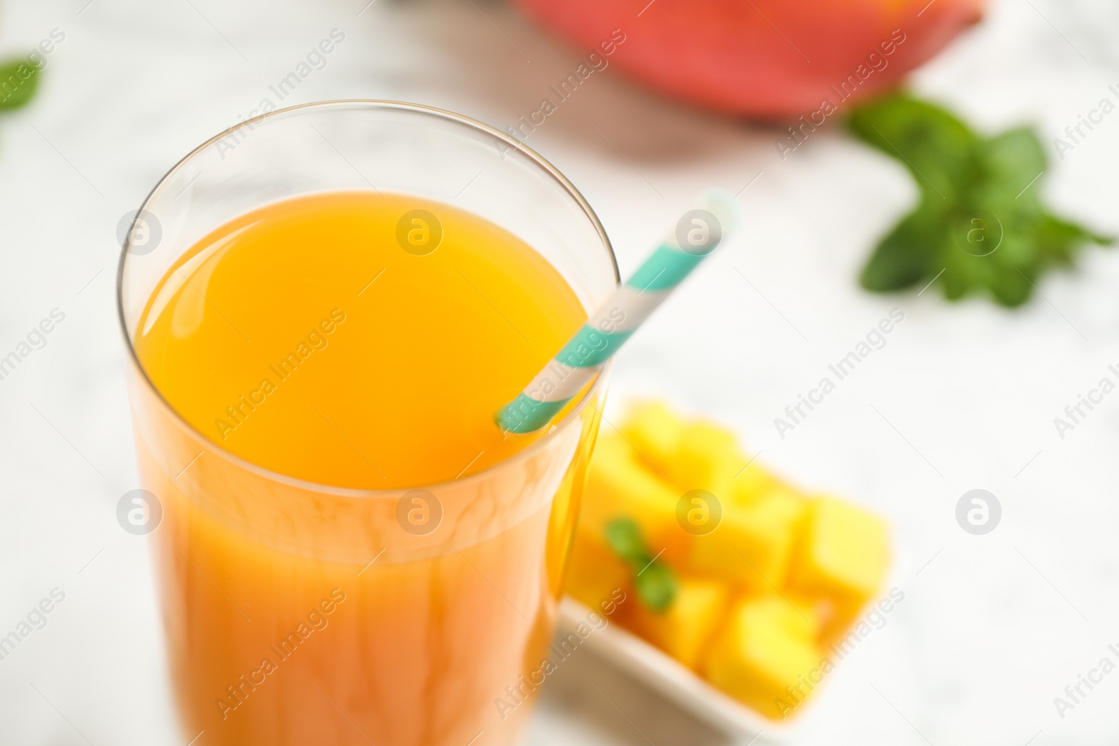 Photo of Fresh delicious mango drink on table, closeup