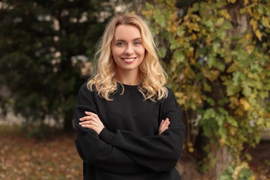 Photo of Happy woman in stylish warm sweater outdoors