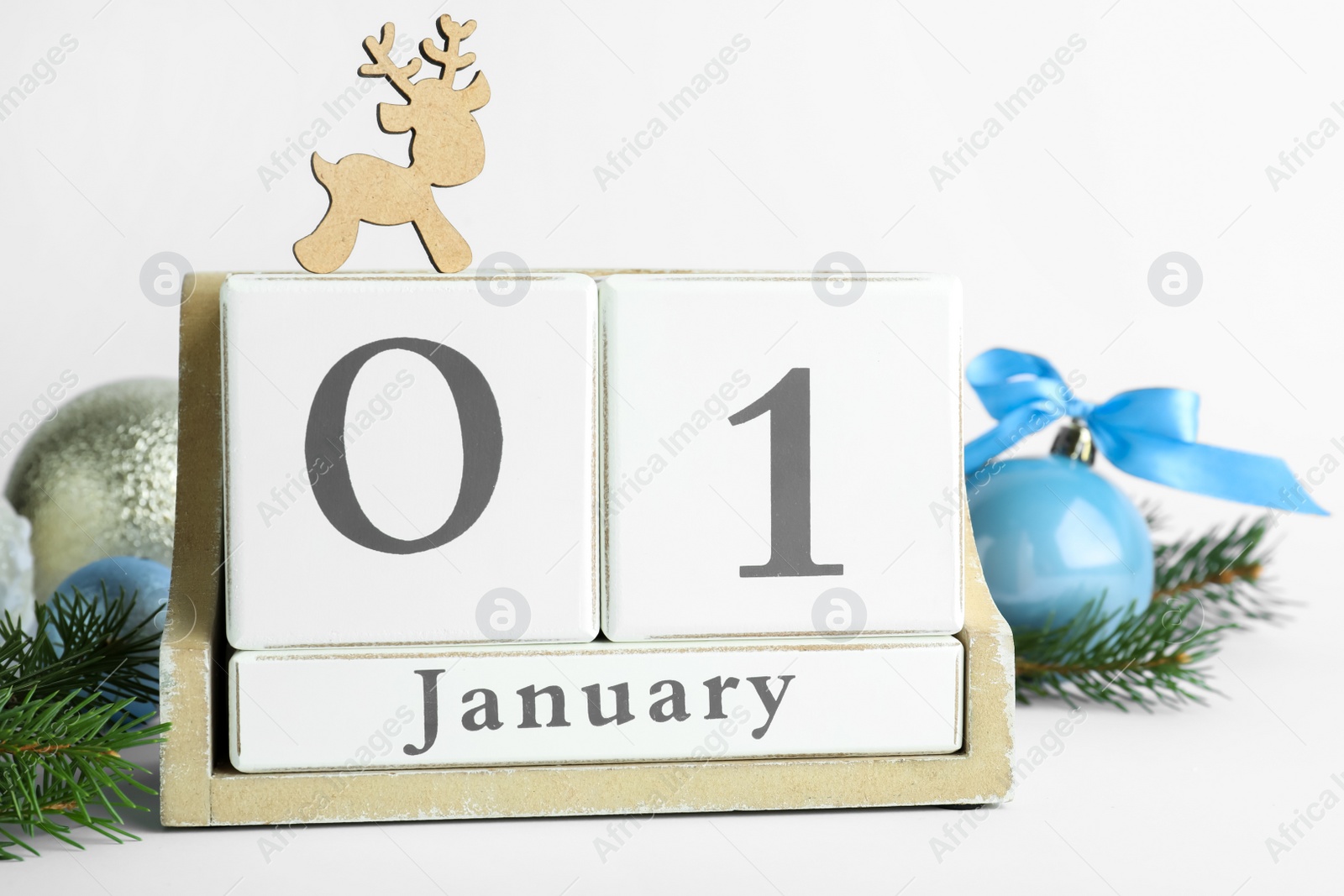 Photo of Block calendar and Christmas decor on white background. New Year celebration