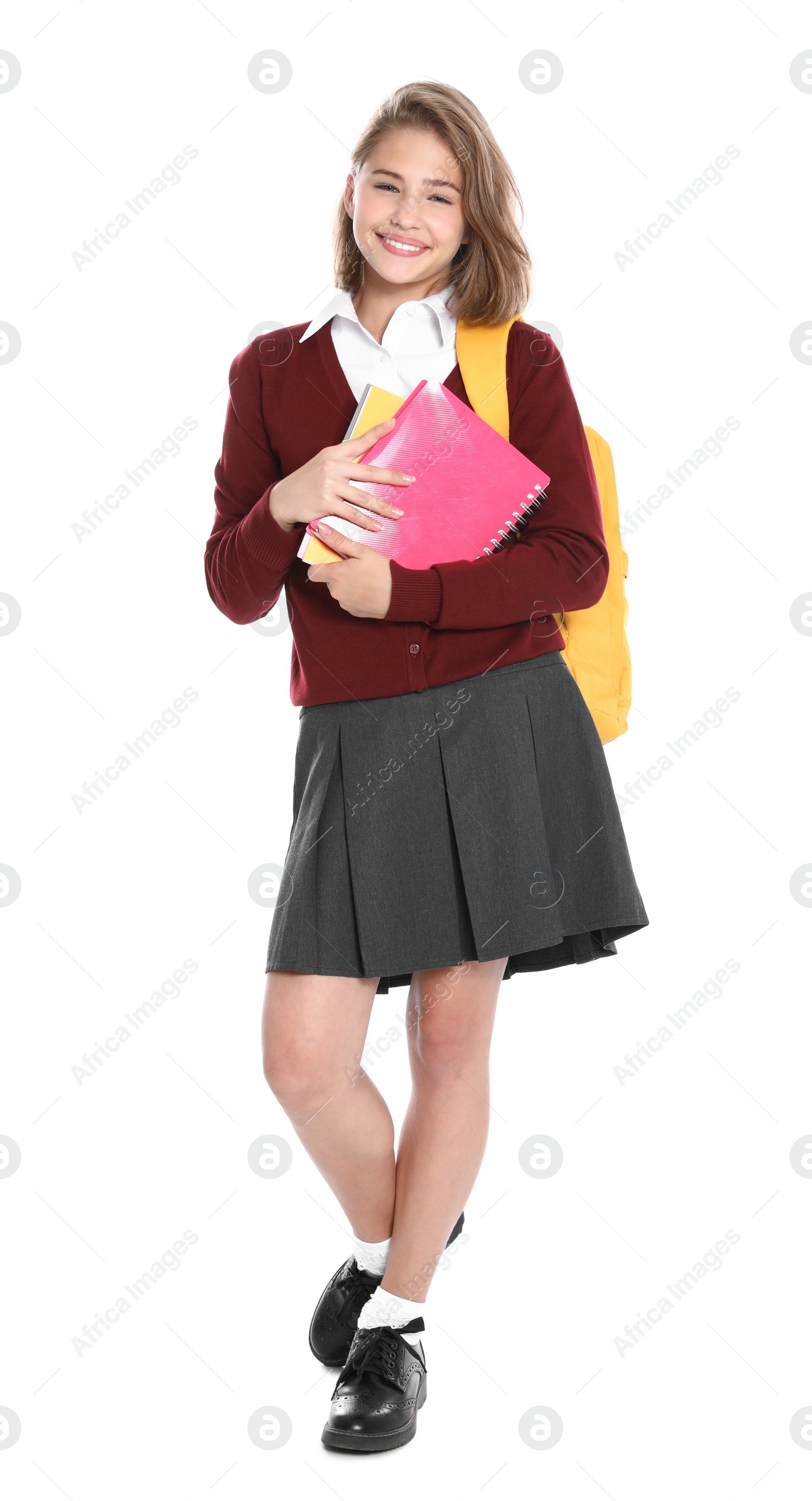 Photo of Happy girl in school uniform on white background