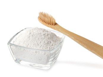 Photo of Glass bowl of tooth powder and brush on white background