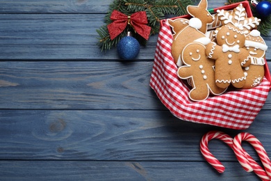 Photo of Decorated Christmas cookies on blue wooden table, flat lay. Space for text