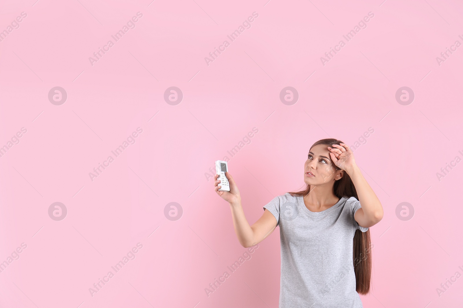 Photo of Young woman suffering from heat on color background with copy space text. Air conditioner malfunction