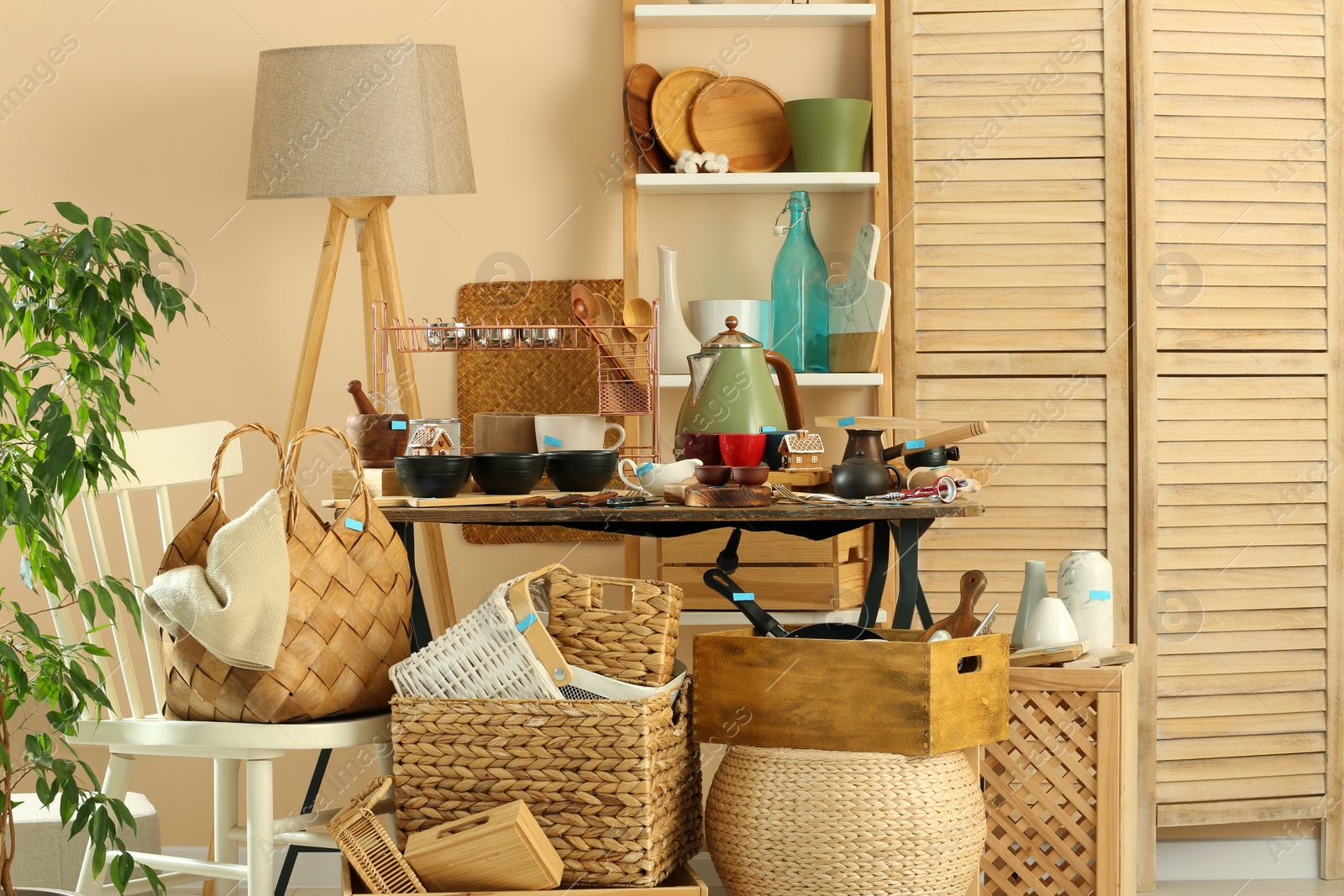 Photo of Many different cooking utensils in room. Garage sale