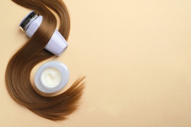 Photo of Natural cosmetic products and hair lock on beige background, flat lay. Space for text