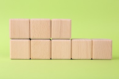 Photo of International Organization for Standardization. Wooden cubes with abbreviation ISO and number 18001 on light green background
