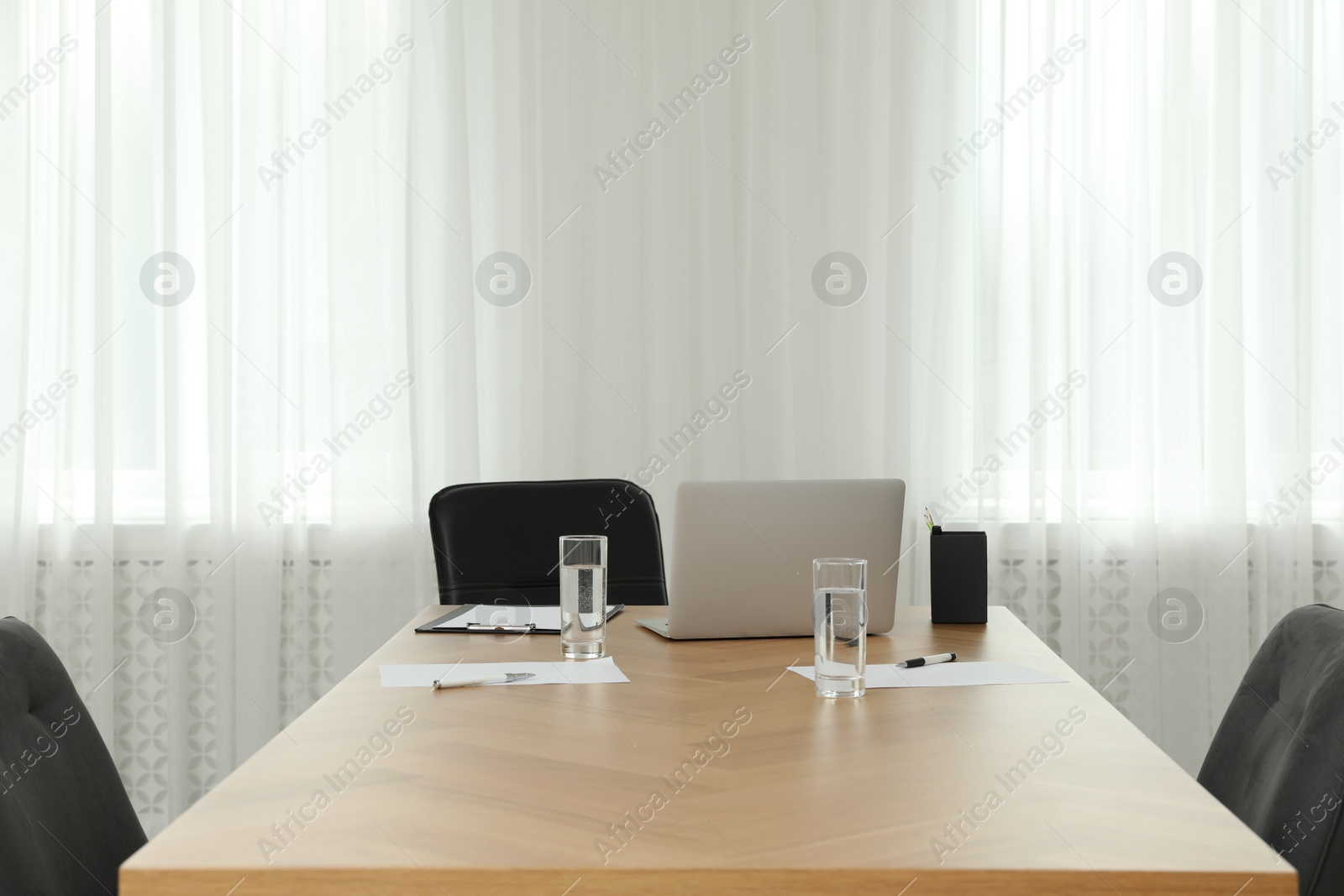 Photo of Director's office with large wooden table and comfortable armchairs. Interior design