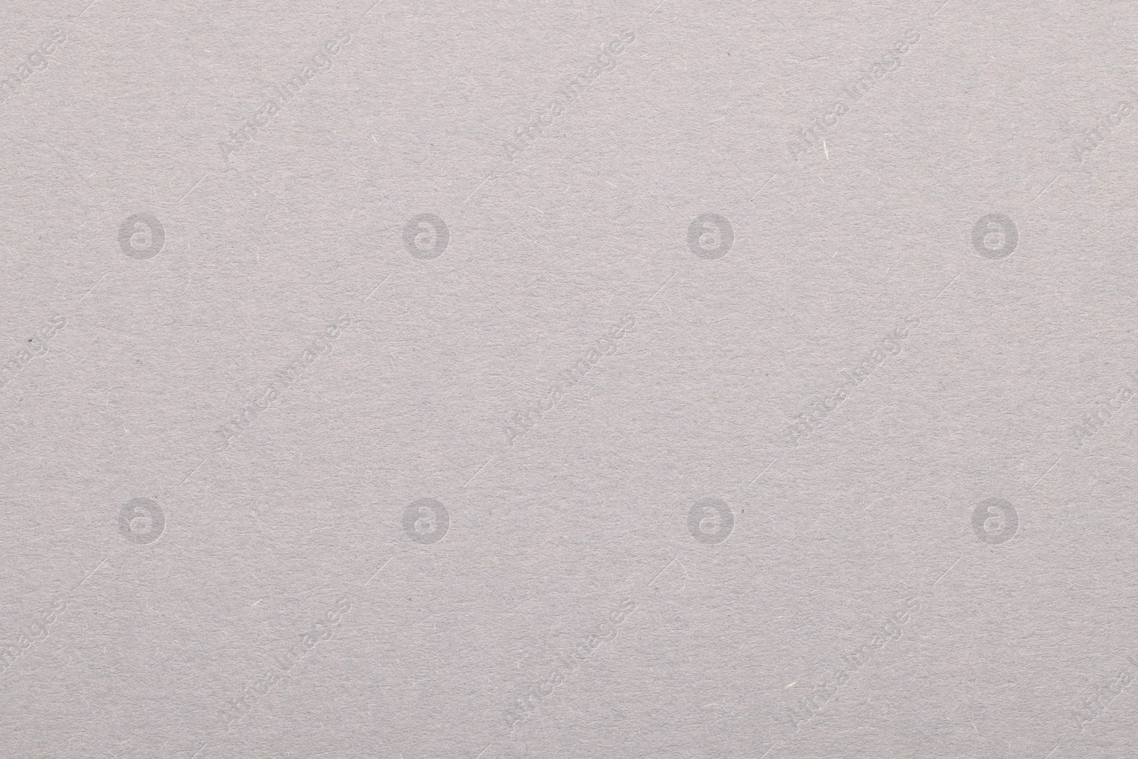 Photo of Texture of light grey paper sheet as background, top view