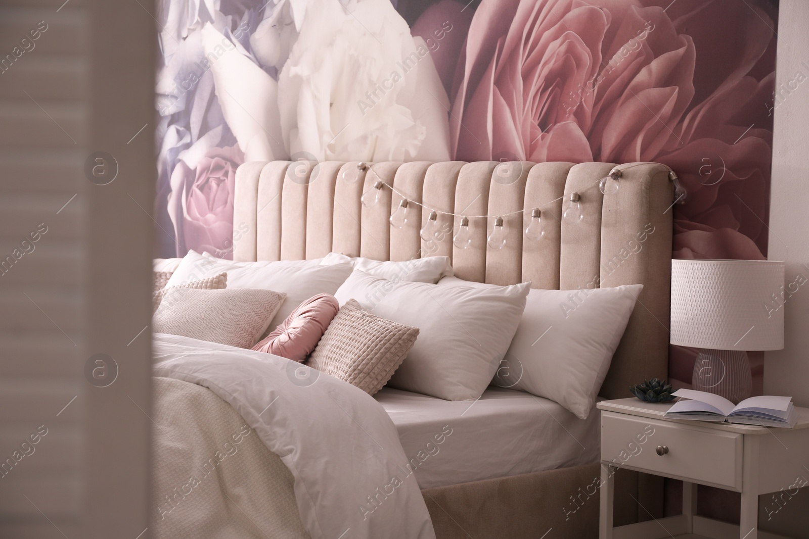 Photo of Stylish floral room interior with comfortable bed