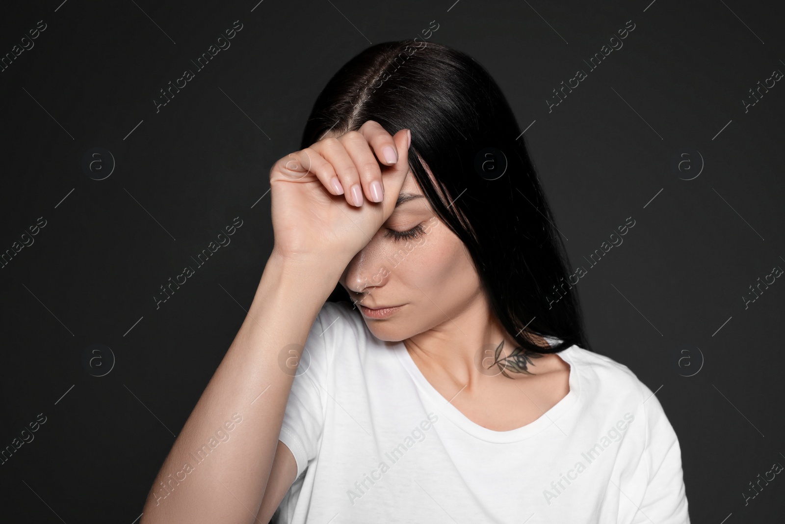 Photo of Portrait of upset young woman on dark background