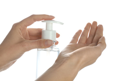 Woman applying antibacterial hand gel against white background, closeup