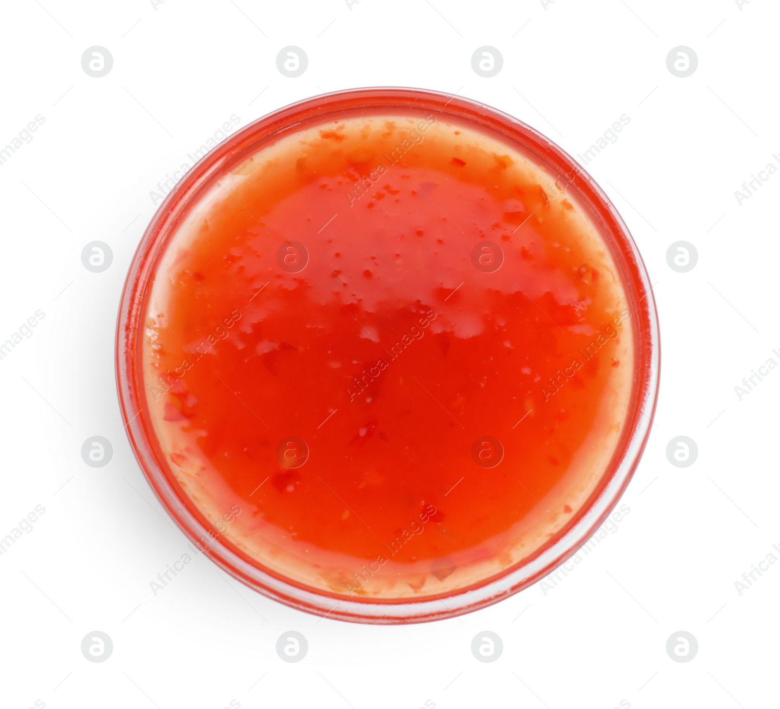 Photo of Spicy chili sauce in bowl isolated on white, top view