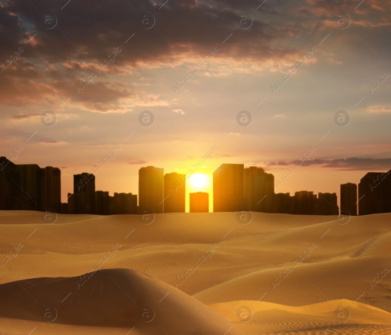 Image of Sandy desert and silhouette of city on horizon at sunset