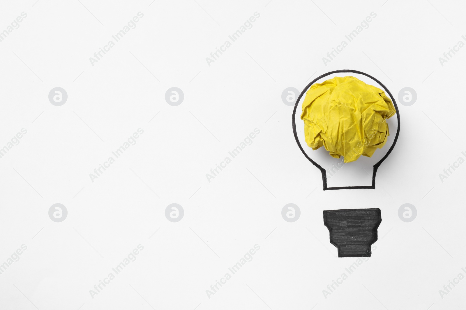 Photo of Idea concept. Light bulb made with crumpled paper and drawing on white background, top view. Space for text