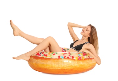 Photo of Beautiful young woman in stylish bikini with doughnut inflatable ring on white background