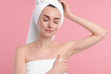 Photo of Beautiful woman showing armpit with smooth clean skin on pink background