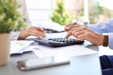 Tax accountants working with documents at table