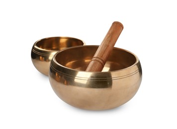 Tibetan singing bowls and wooden mallet on white background