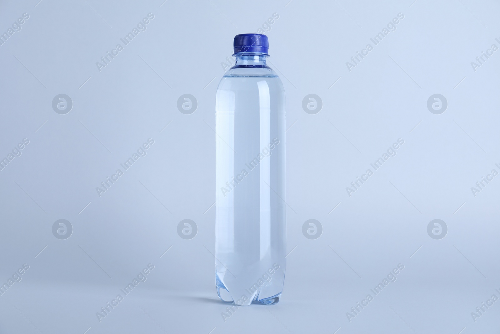 Photo of Plastic bottle with water on white background