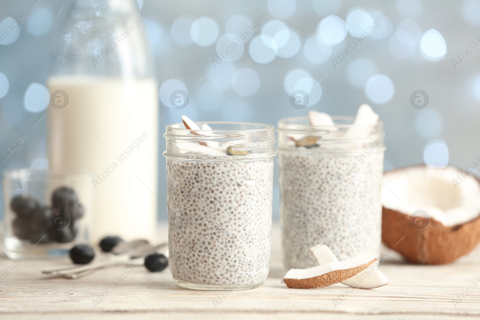 Photo of Tasty chia seed pudding with on table against blurred background