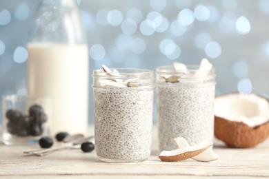 Photo of Tasty chia seed pudding with on table against blurred background