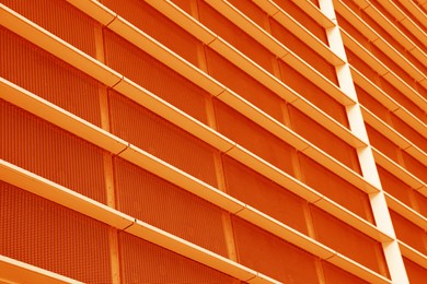 Image of Modern building, low angle view. Toned in orange color
