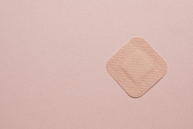 Photo of Contraceptive patch on pink background, top view. Space for text