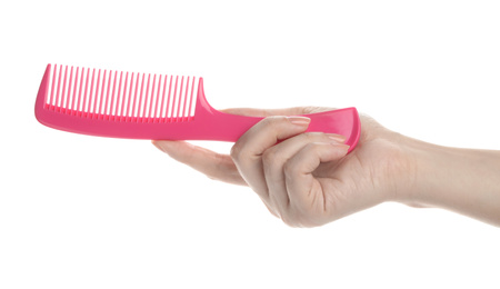 Woman holding hair comb on white background, closeup