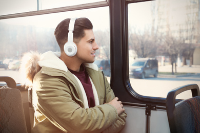 Man listening to audiobook in trolley bus