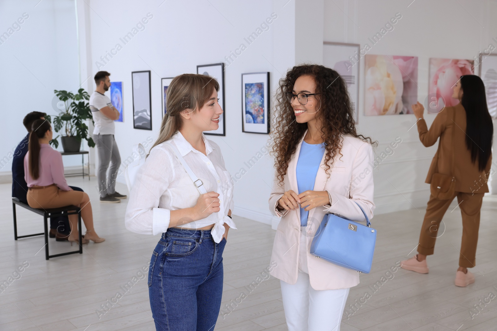 Photo of Young women at exhibition in art gallery