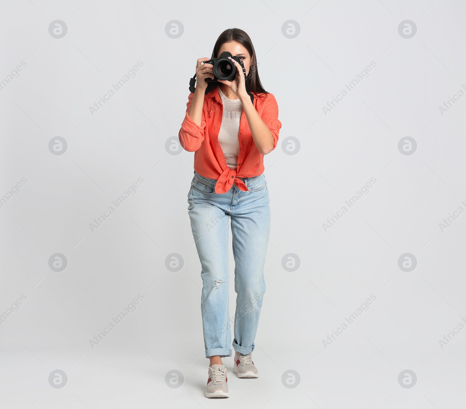 Photo of Professional photographer working on white background in studio