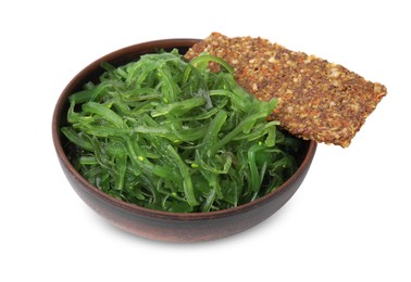 Photo of Tasty seaweed salad in bowl and crispbread isolated on white