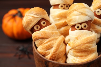 Spooky sausage mummies for Halloween party served on table, closeup