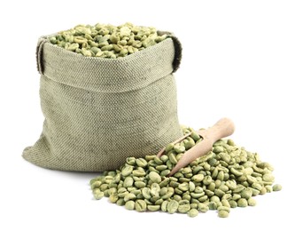 Photo of Green coffee beans, wooden scoop and sackcloth bag on white background