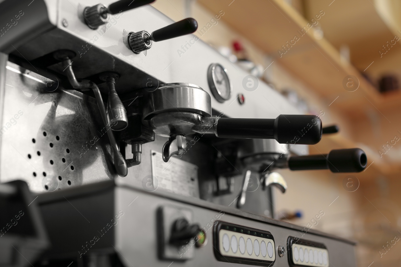 Photo of Modern electric coffee machine with portafilters, closeup