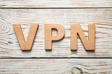 Photo of Acronym VPN made of wooden letters on table, flat lay