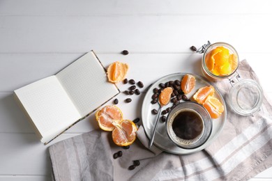 Flat lay composition with many fresh ripe tangerines and book on white wooden table