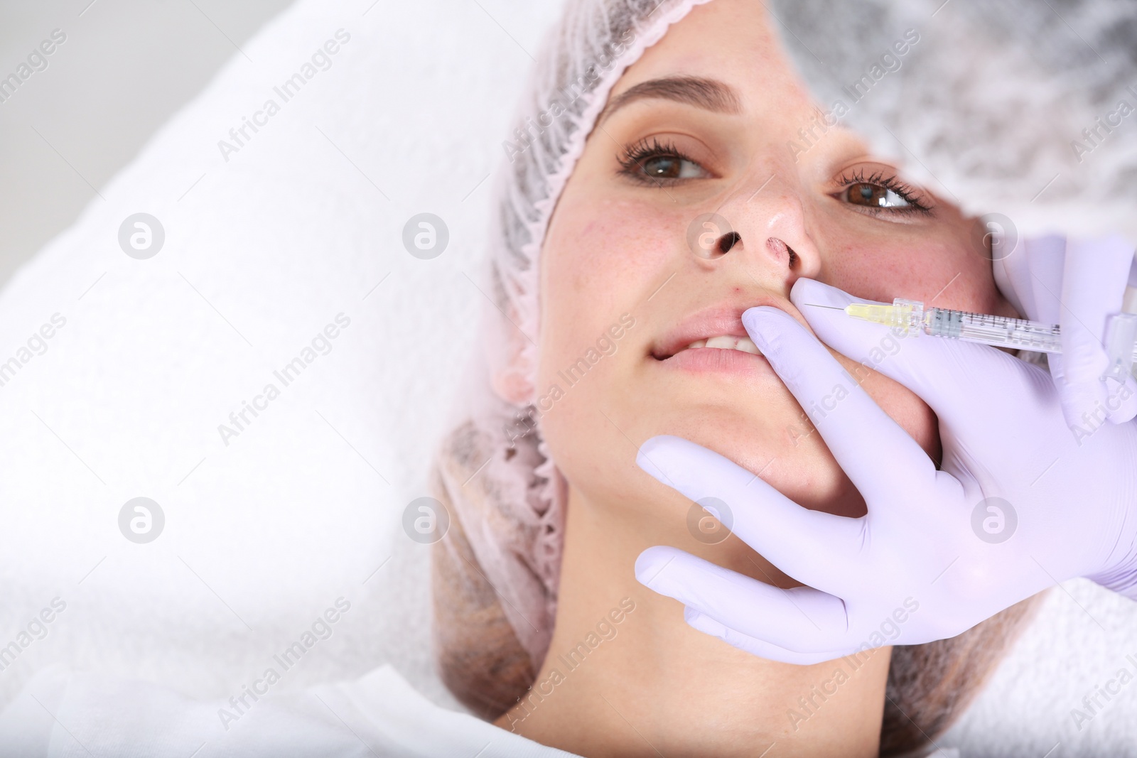 Photo of Woman undergoing face biorevitalization procedure in salon, closeup. Cosmetic treatment