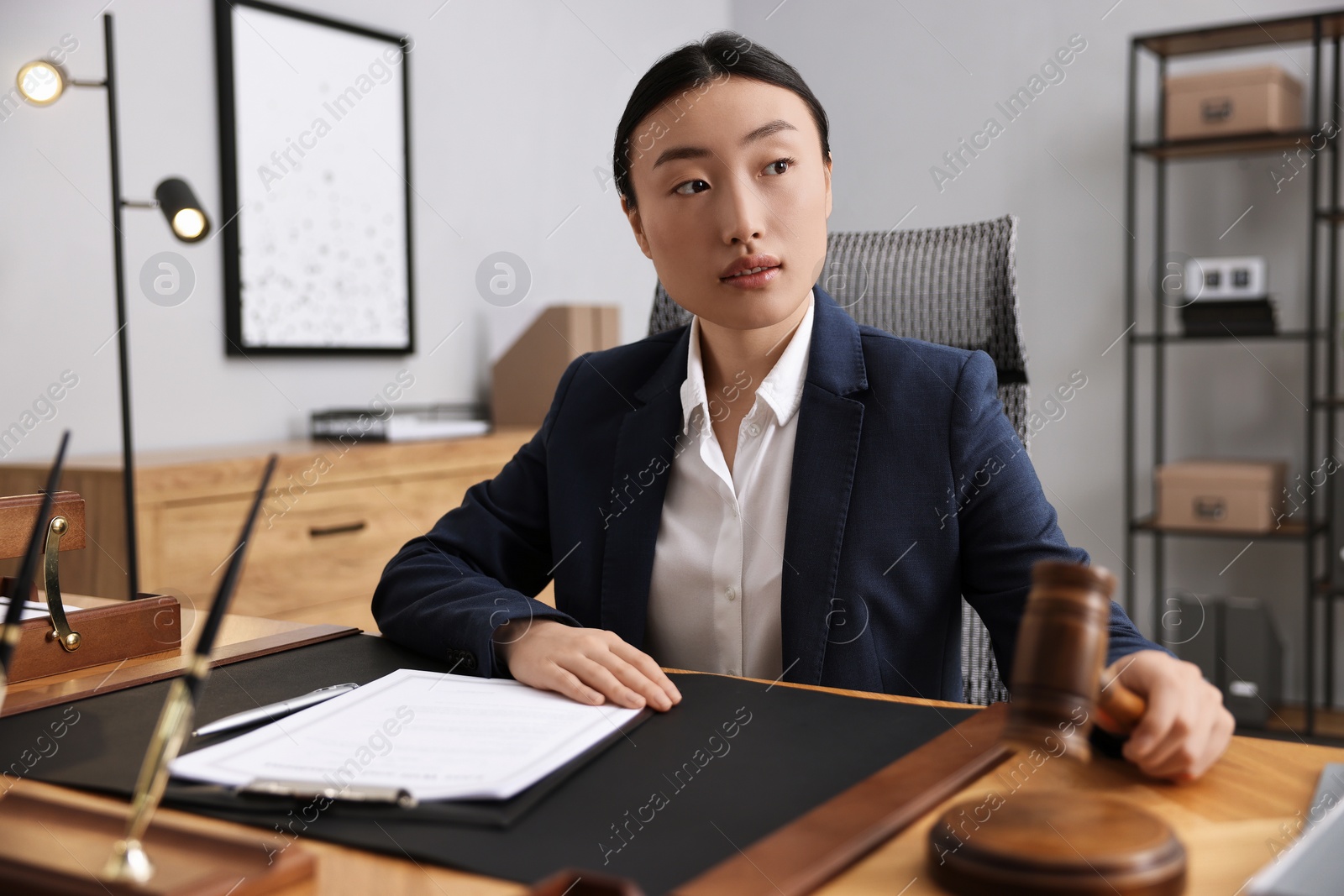 Photo of Notary with gavel at table in office