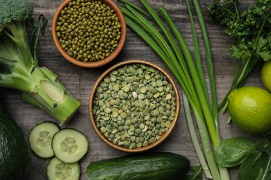 Photo of Different vegetables on wooden table, flat lay. Vegan diet