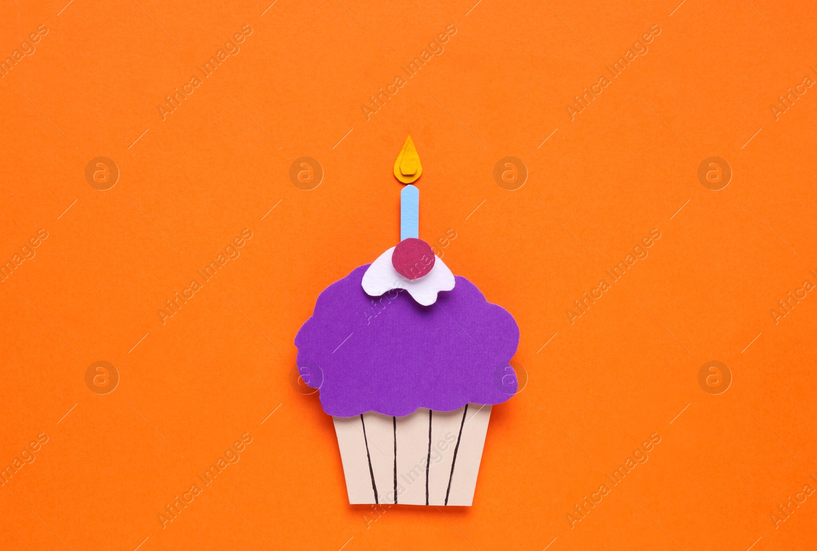 Photo of Birthday party. Paper cupcake on orange background, top view