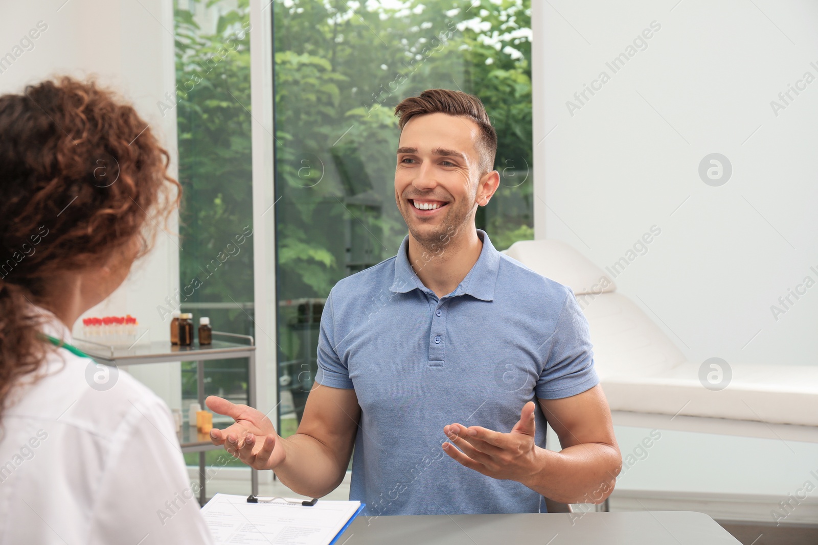 Photo of African American doctor working with patient in hospital