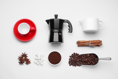 Flat lay composition with geyser coffee maker and roasted beans on white background
