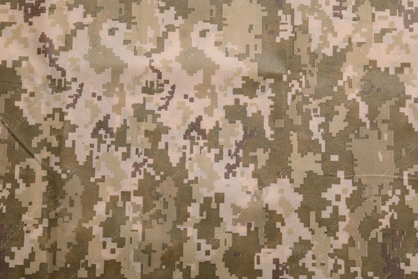 Photo of Texture of camouflage fabric as background, top view