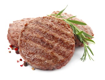 Tasty grilled hamburger patties with seasonings on white background