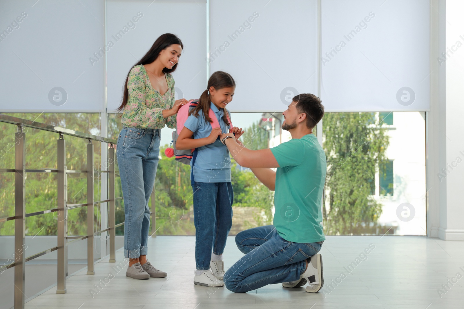 Photo of Parents saying goodbye to their daughter in school