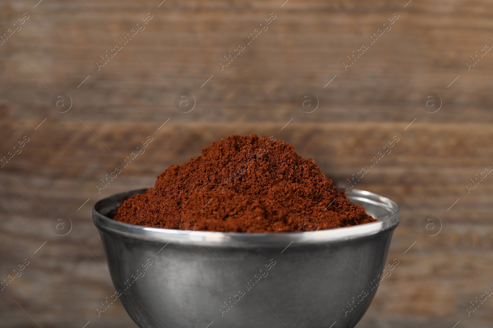 Photo of Ground coffee against wooden background, closeup view