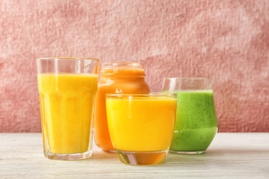 Glassware with delicious detox smoothies on table