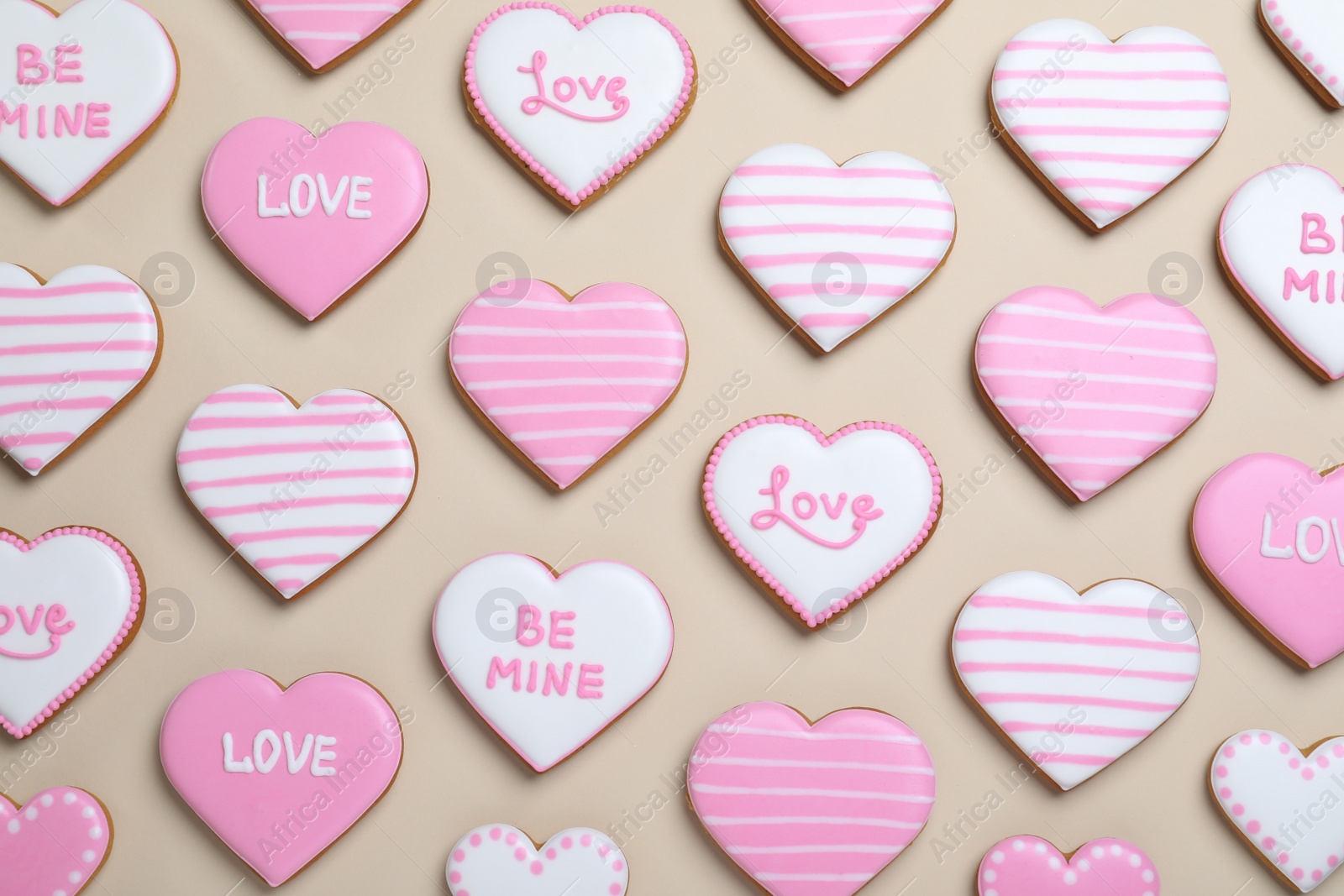 Photo of Delicious heart shaped cookies on beige background, flat lay. Valentine's Day