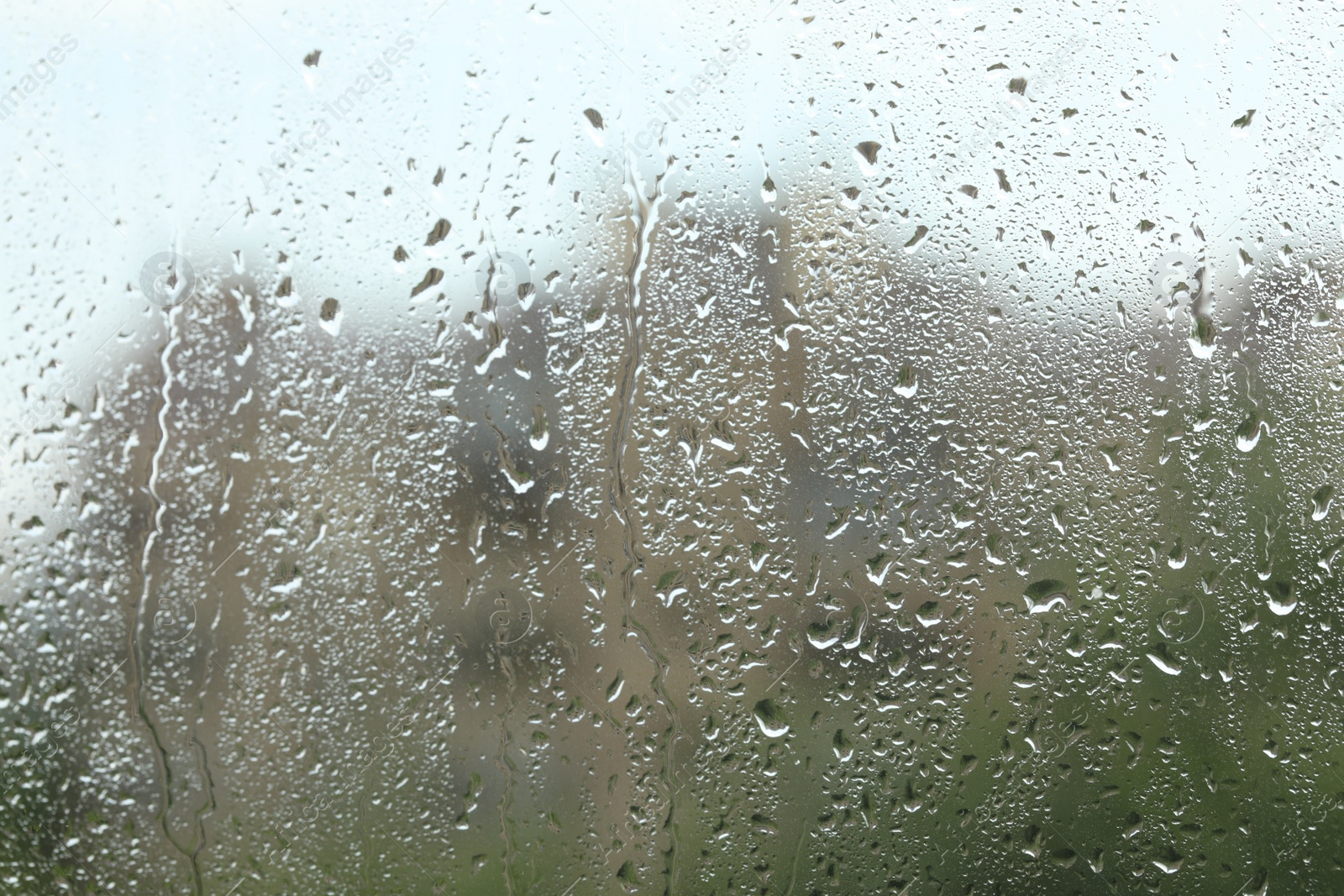 Photo of Window glass with raindrops as background, closeup